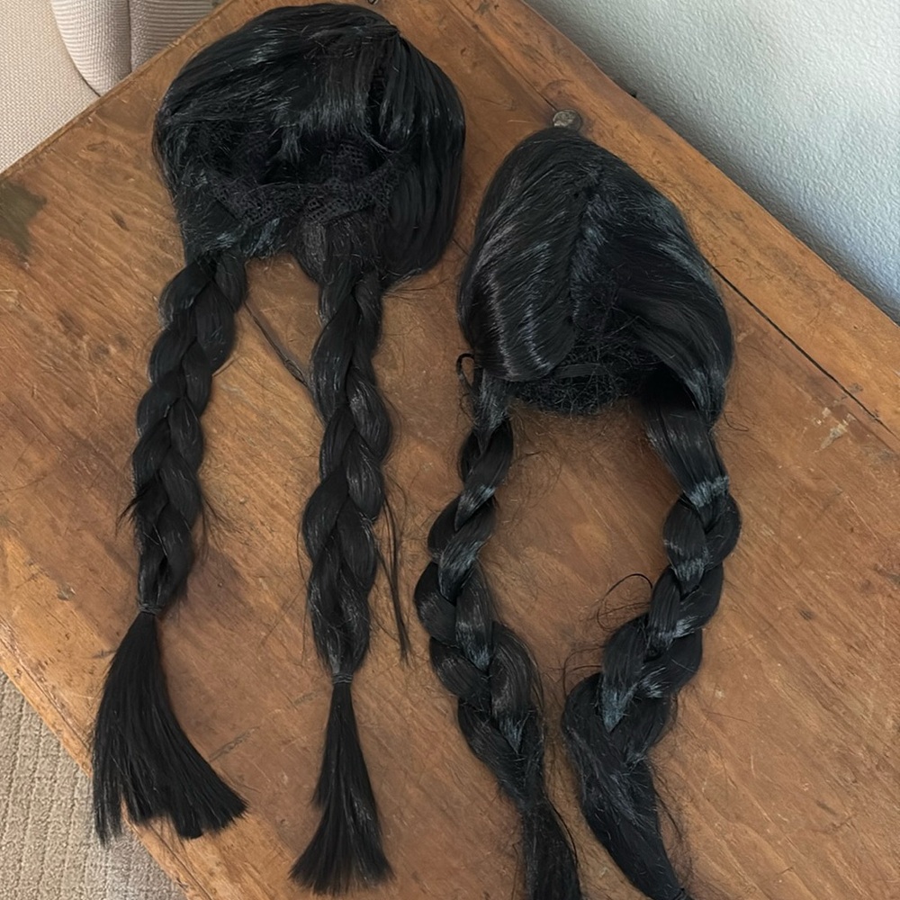 Two black children’s wigs with braids